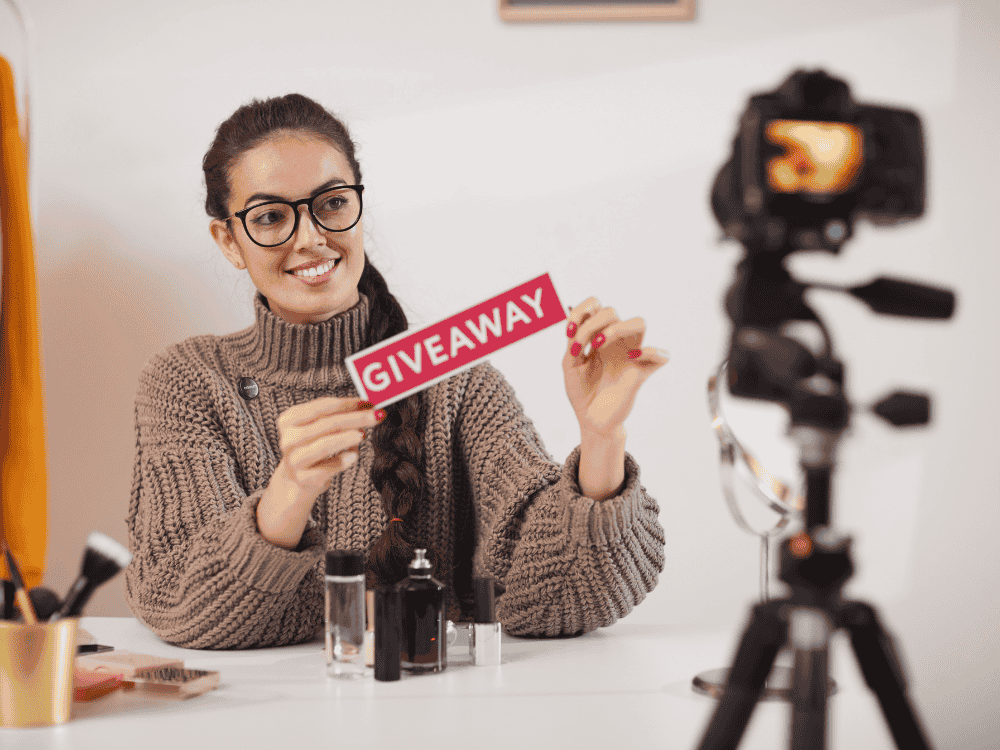 A woman recording a giveaway vlog for her followers using a wireless microphone
