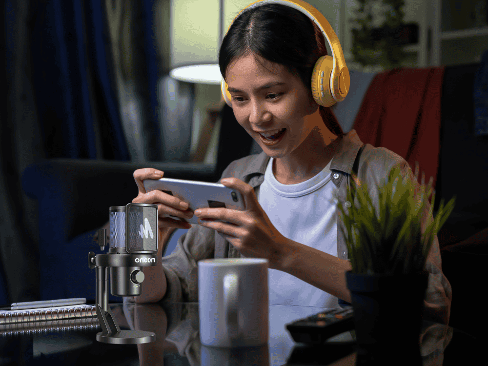 A girl live streaming her mobile game using a gaming microphone