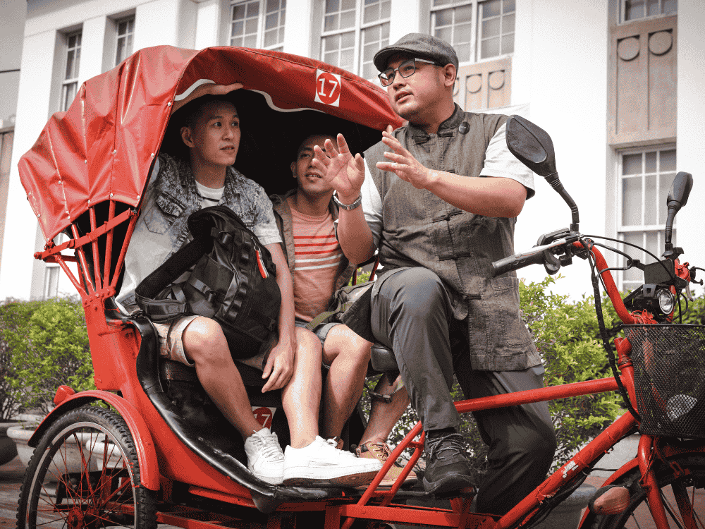 A male tour guide using a wireless microphone for vlogging their trip with consent