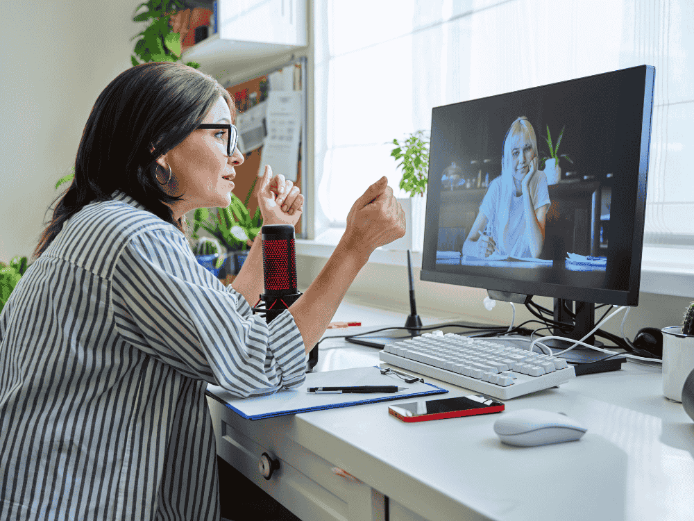 A mental health professional using a podcast microphone while speaking with a patient