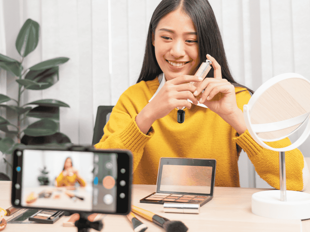 A lady vlogger using a wireless microphone for her makeup transformation vlog