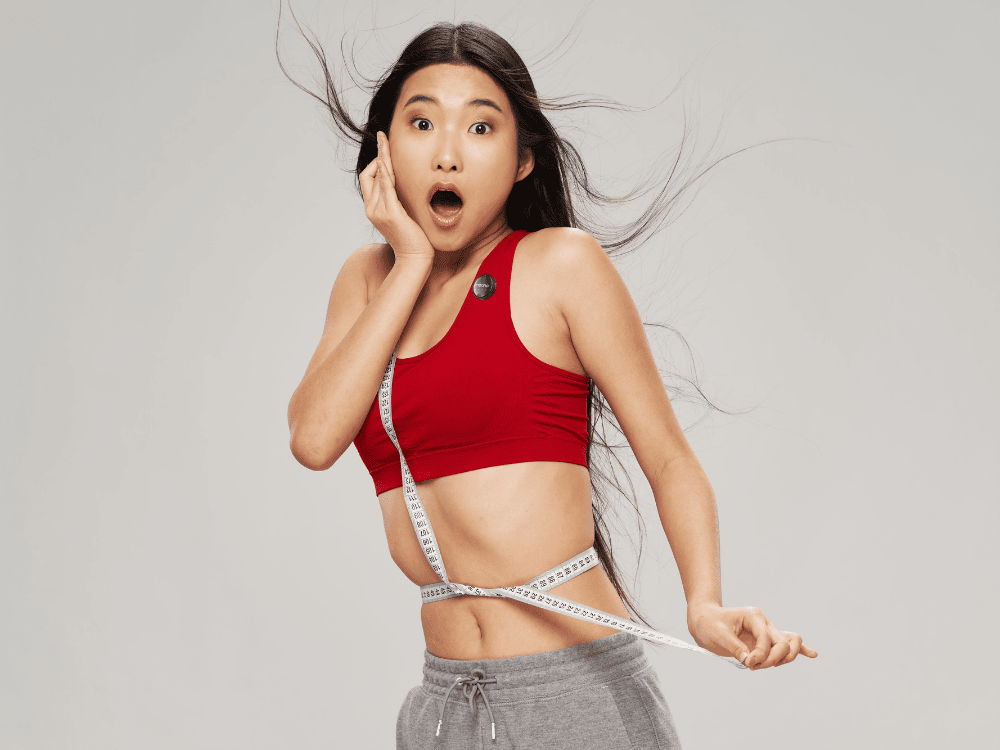 A woman recording her weight-loss vlog using a wireless microphone