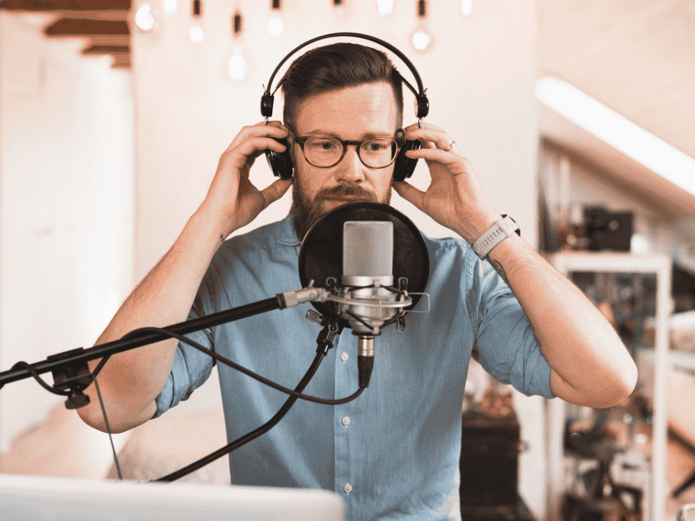 A male podcaster using a podcast mic for an episode