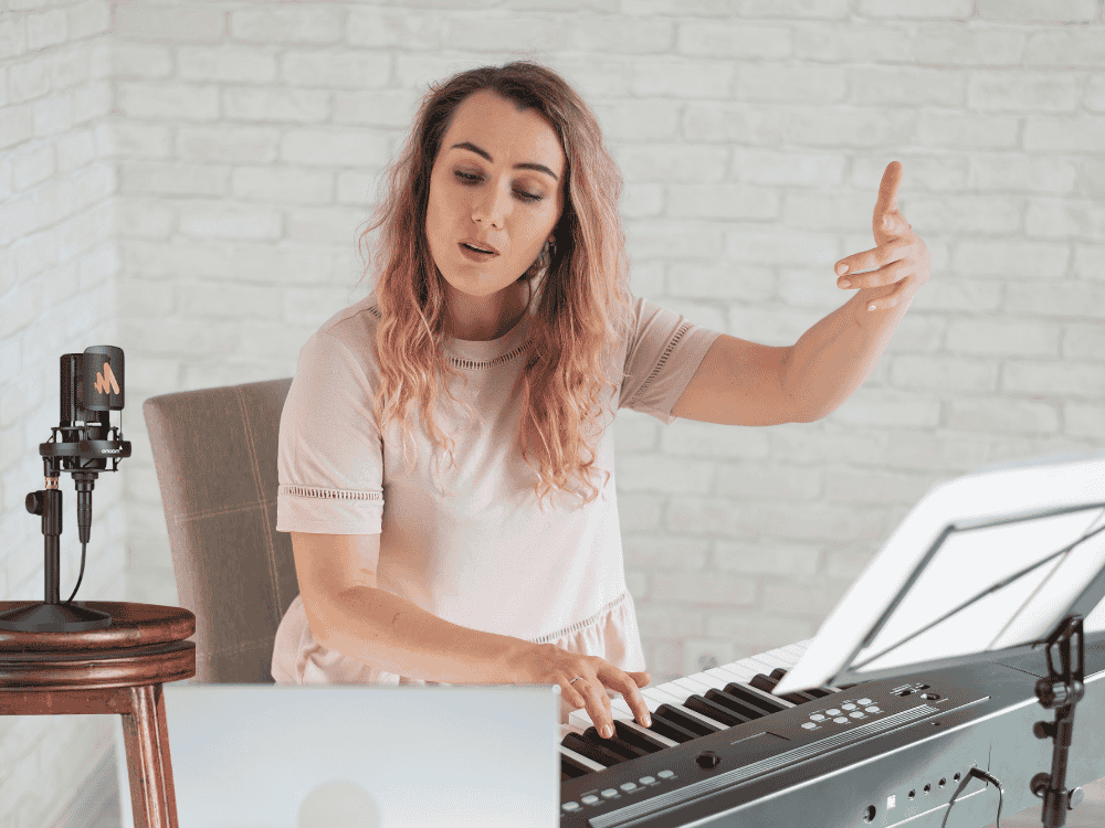 A music teacher recording her piano music for her Facebook video