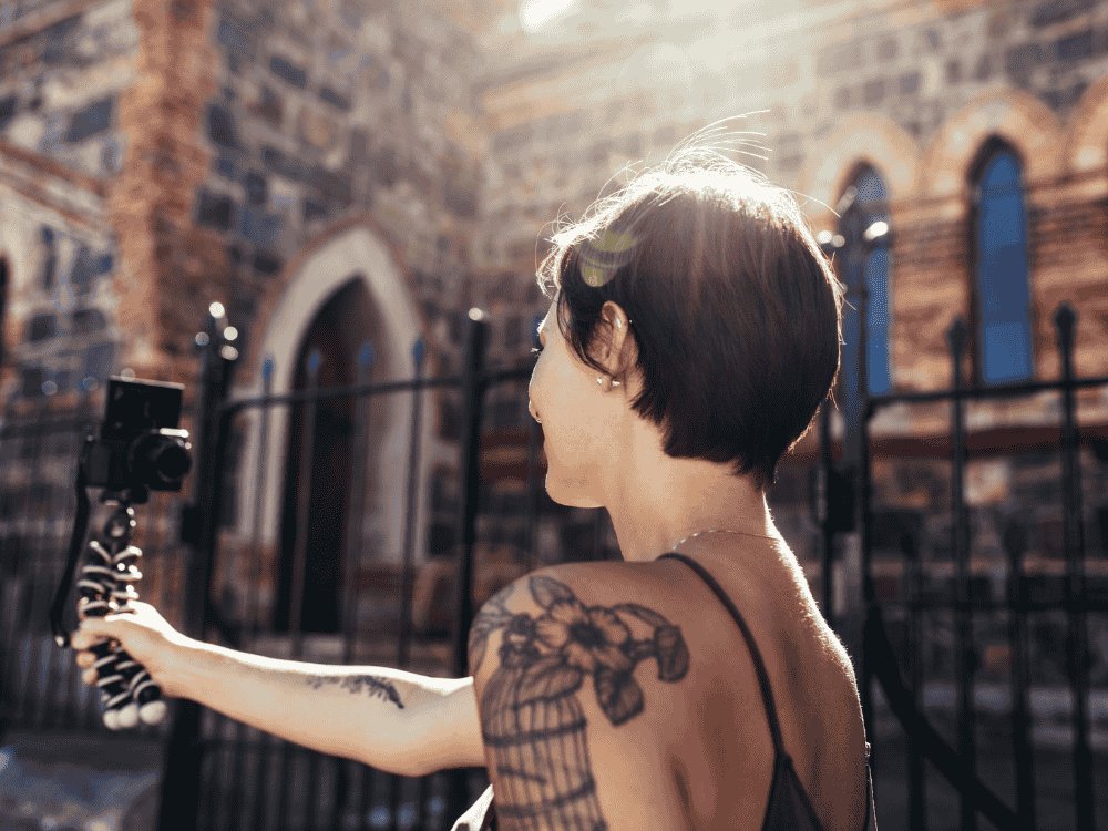 A woman filming daily routine vlogs with a camera and wireless microphone