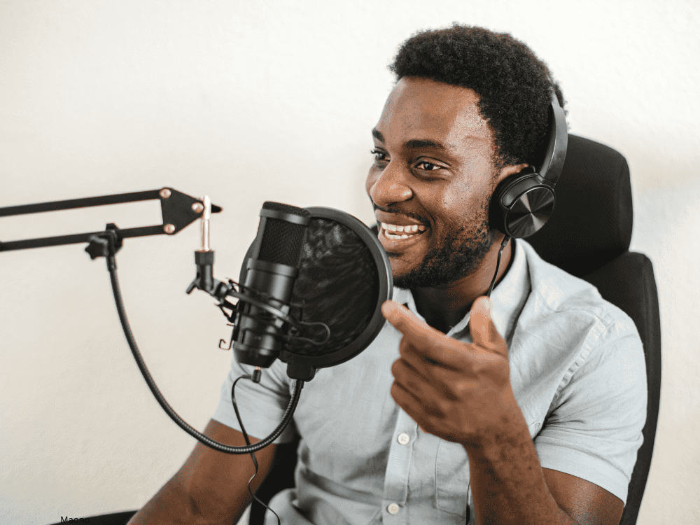 Podcaster Using A Microphone Essential Boom Arm Tips for Podcasting- Setup, Microphones & More