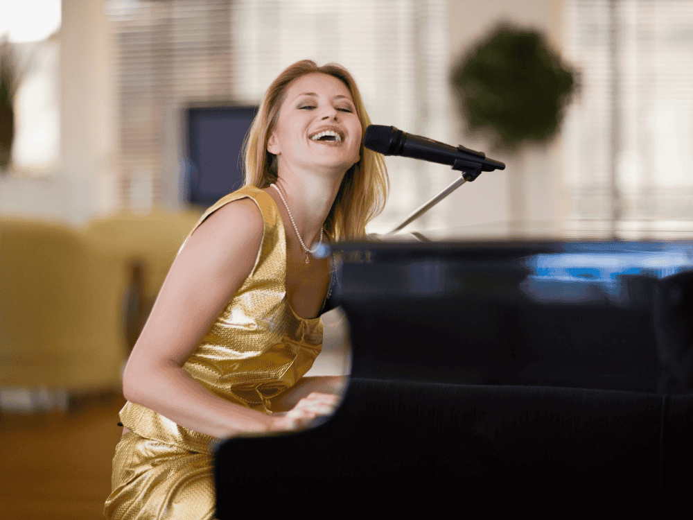 A pianist recording her piano covers using a condenser mic