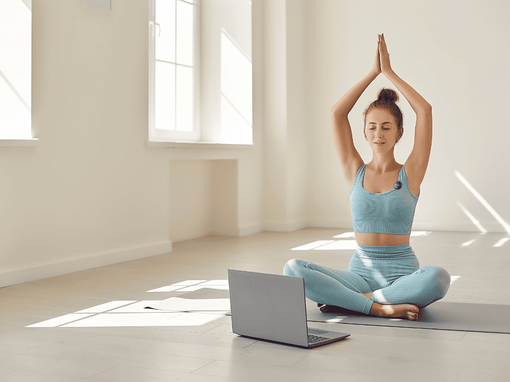 A fitness instructor teaching yoga while using a wireless microphone for her fitness vlog