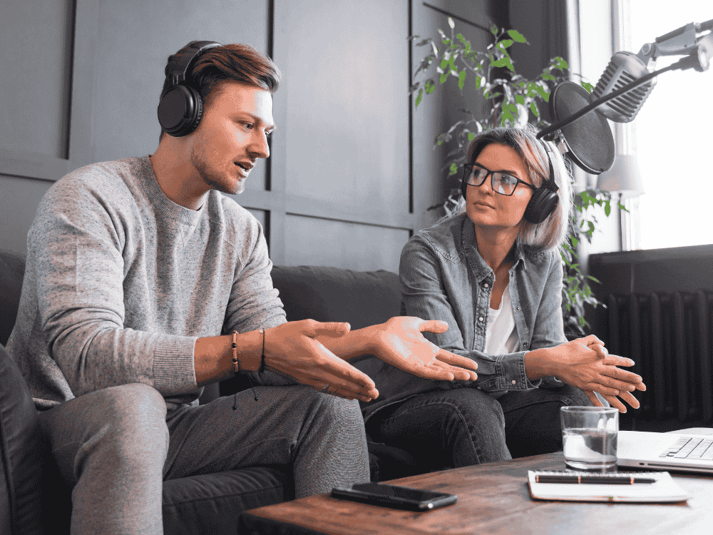 2 persons doing recording a podcast with a podcast mcrophone
