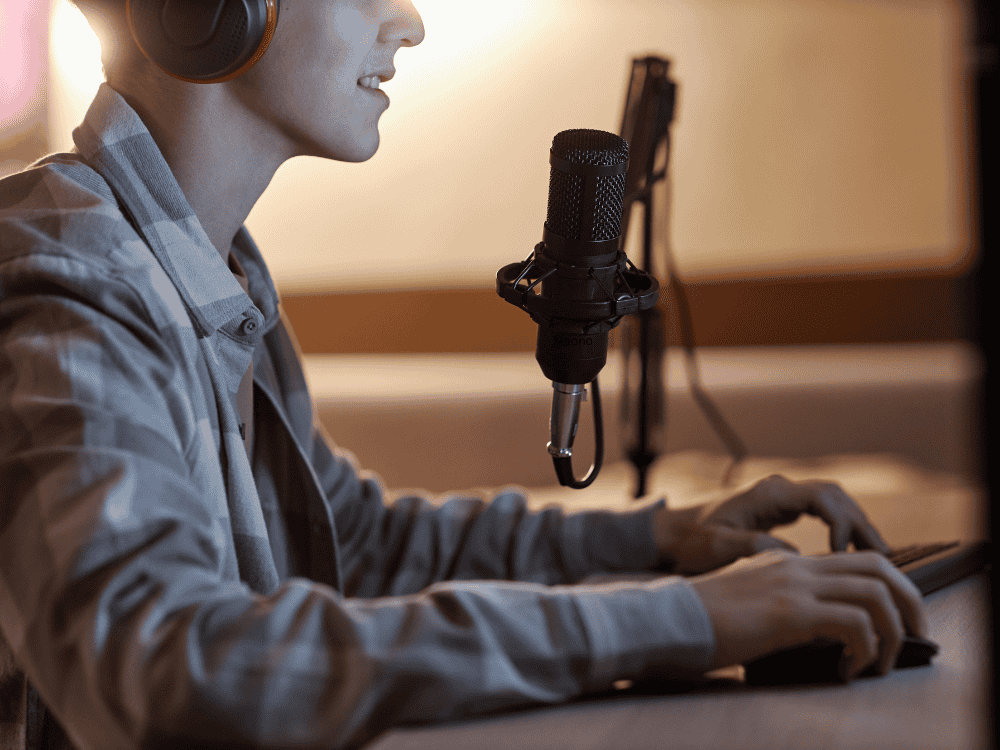 A male gamer streaming using a condenser microphone