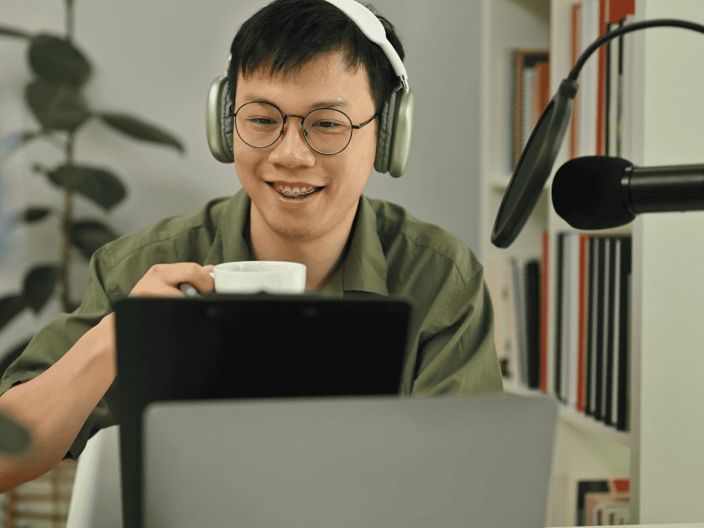 A male podcaster using a podcast microphone with mic stand for Facebook Live