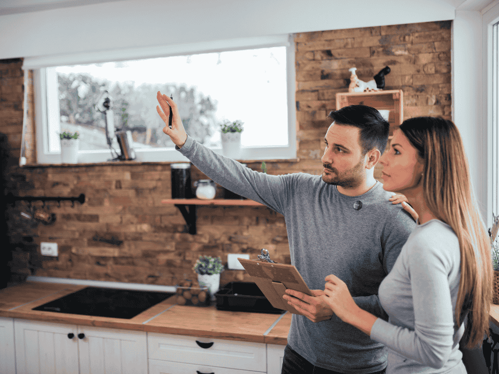A couple recording a home renovation vlog using a wireless microphone