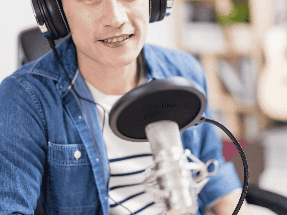 A male content creator storytelling using streaming microphone via Facebook and YouTube