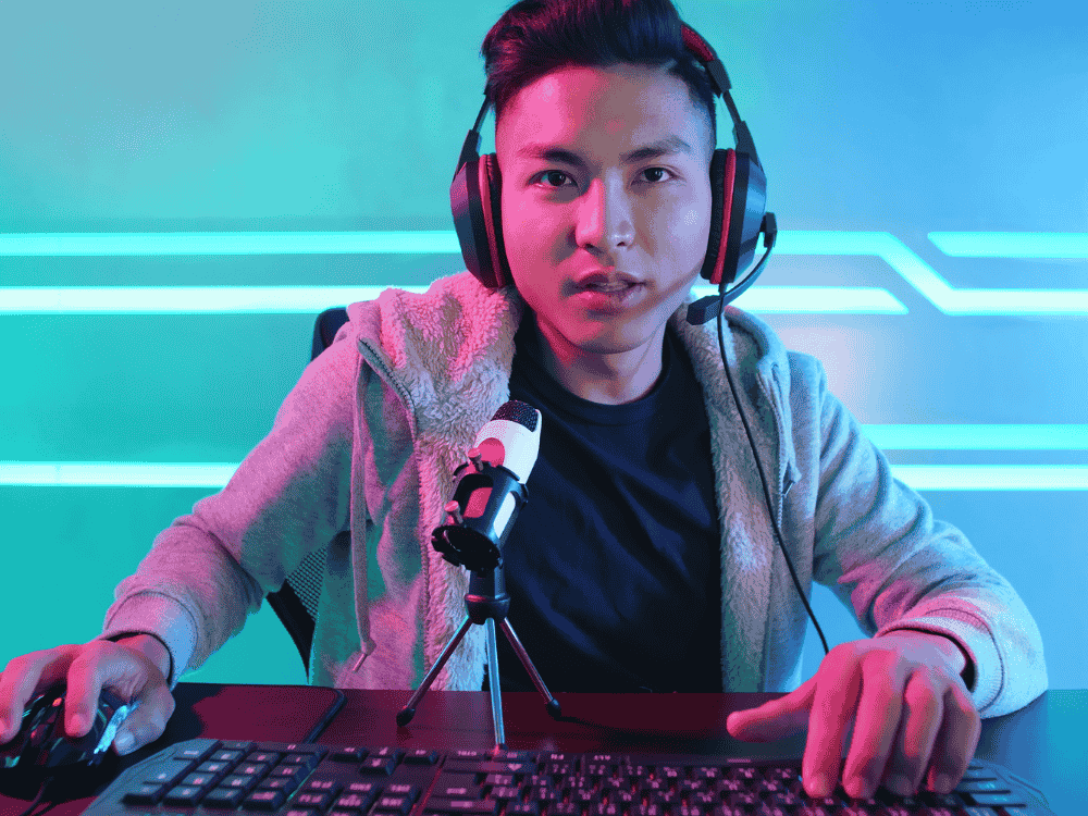 A male content creator using a wireless gaming microphone for streaming