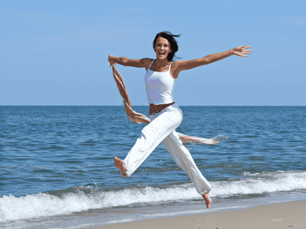 A happy woman showing how she feels prioritizing a healthy lifestyle