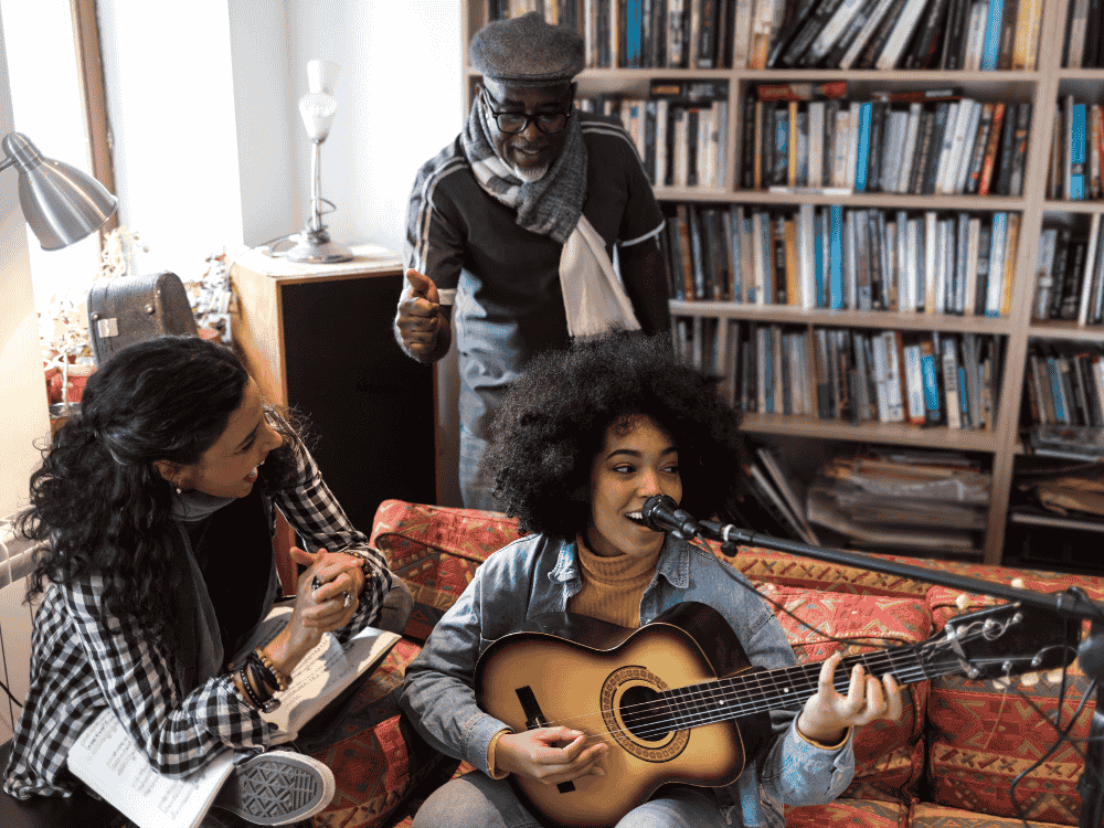 A family recording music using a microphone for singing