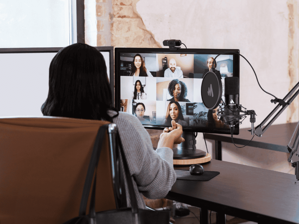 A woman hosting a virtual meeting using a cardioid mic