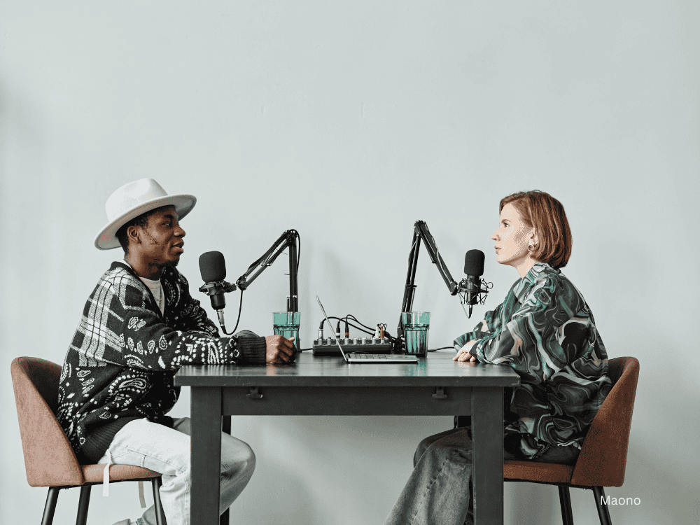 2 persons recording a podcast using an audio interface for pc outputs