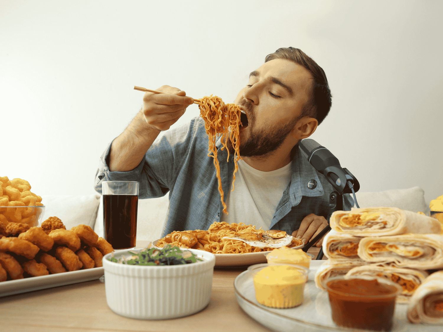 a vlogger doing a mukbang and recording with a wireless microphone
