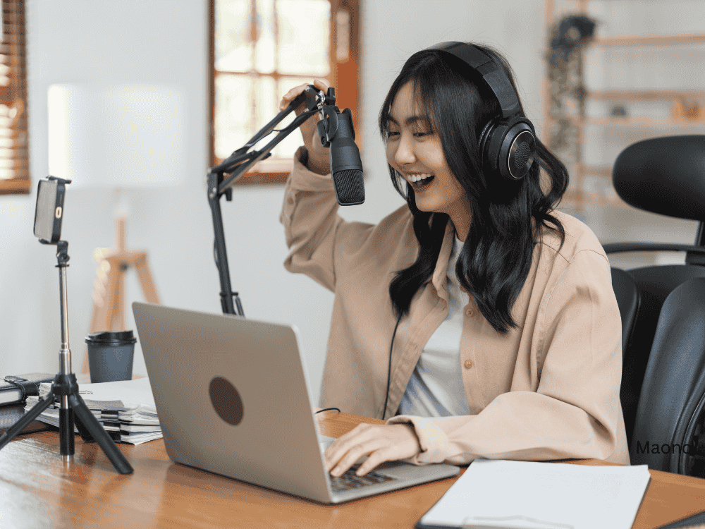 a lady recording using a podcast microphone