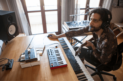 male producing music in a home music studio