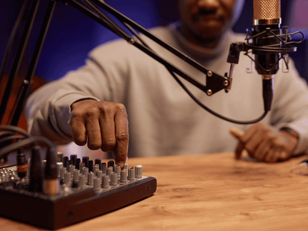 male using a microphone and audio mixer for podcast