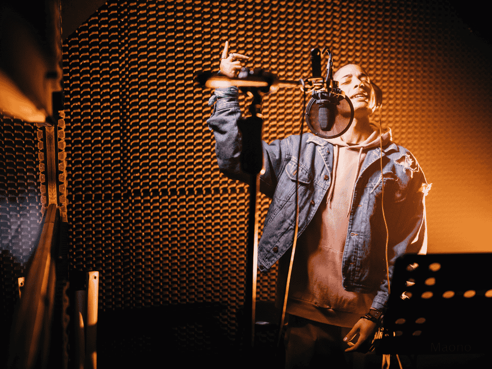 male using microphone for singing in a studio