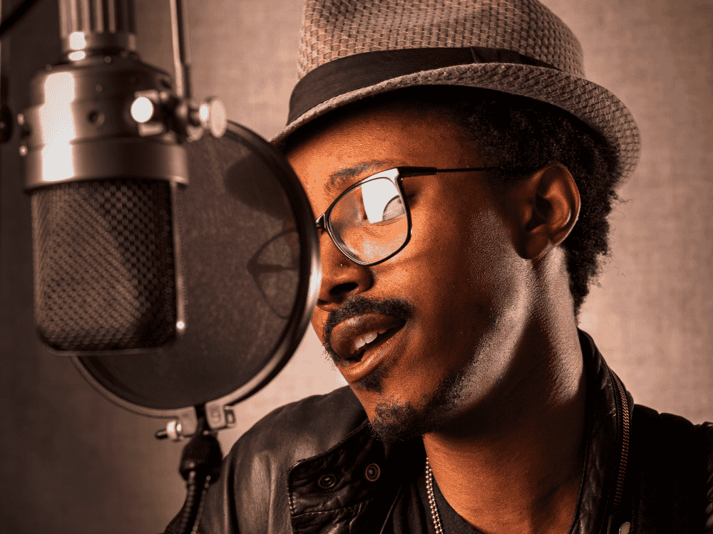 male musician singing in studio using a USB microphone for vocals