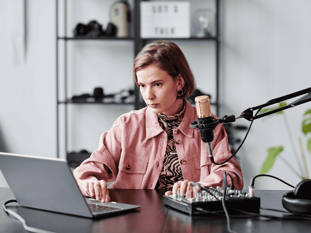 woman using audio interface and microphone for audio recording